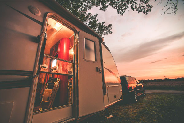 customer enjoying a beautiful sunset in an RV he financed with a recreational vehicle loan at Preferred Credit Union.